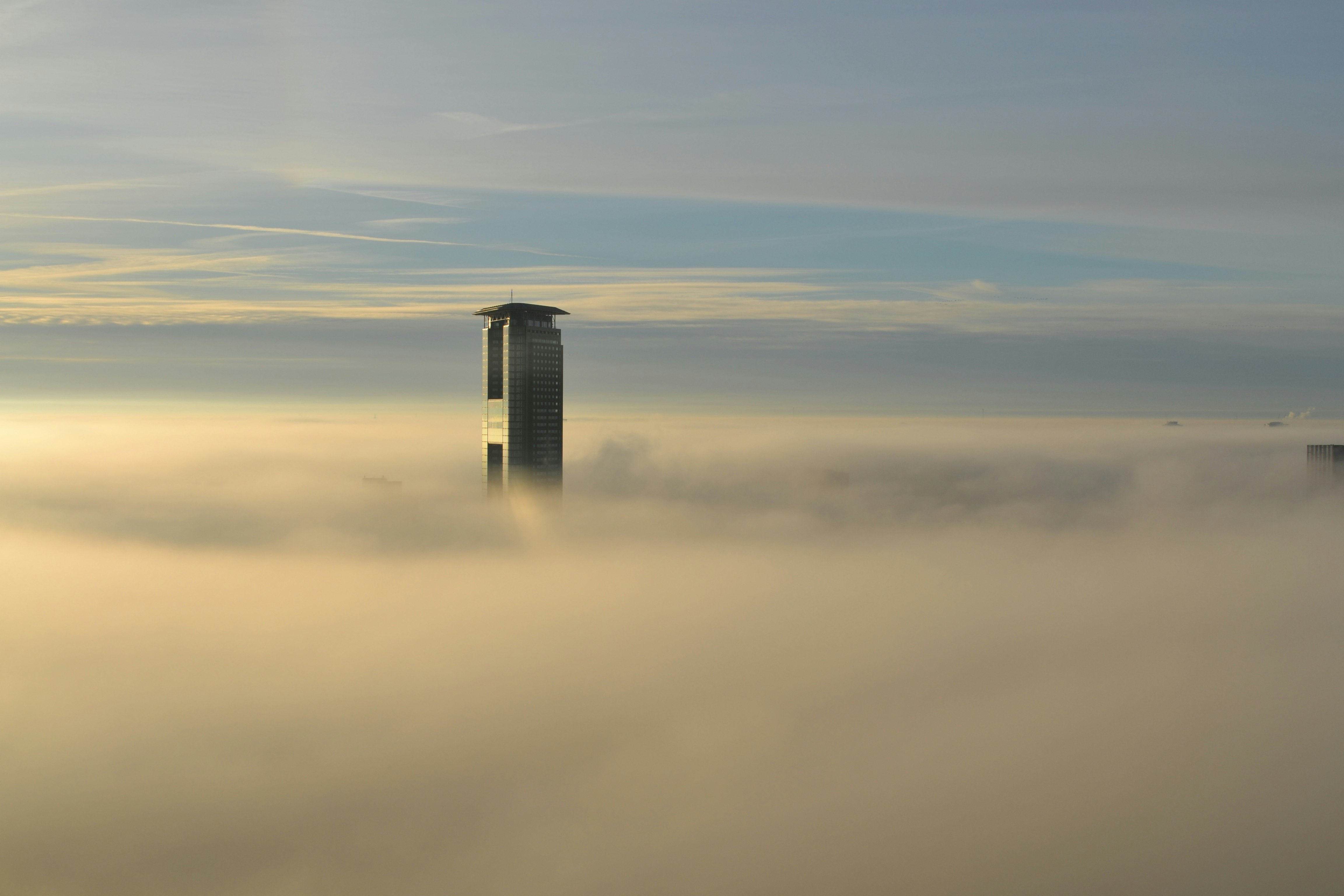 aerial view of skyscraper piercing clouds